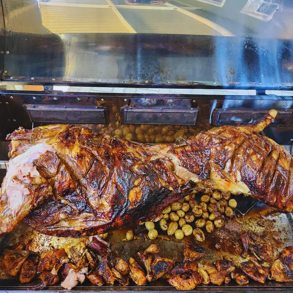 Spit-roasted lamb ready for carving at an event