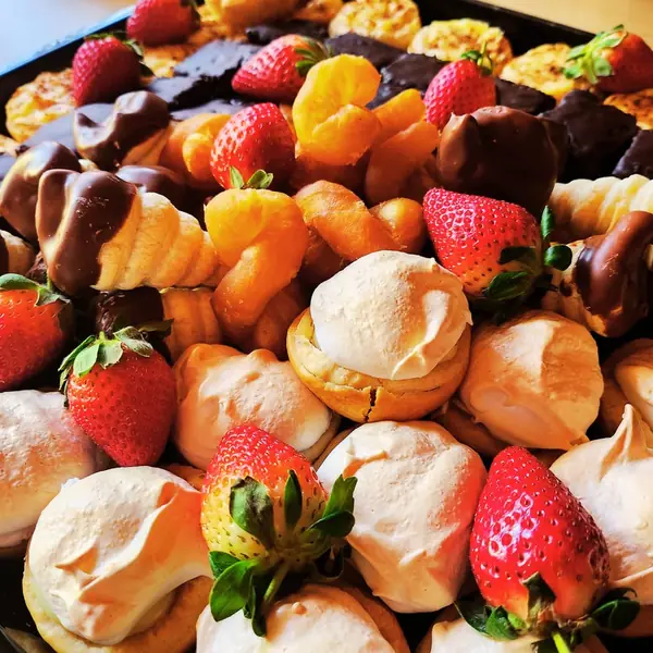 Sweet platter with chocolate-dipped strawberries and meringues